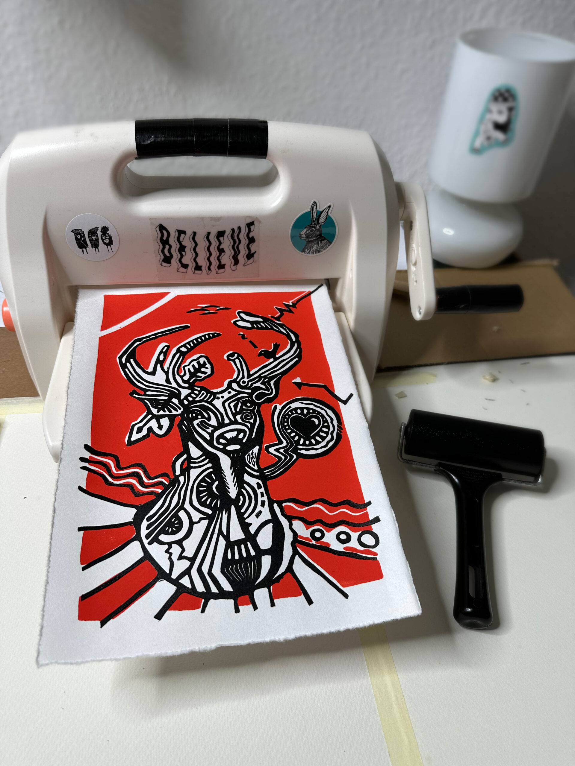 deer lino print on press