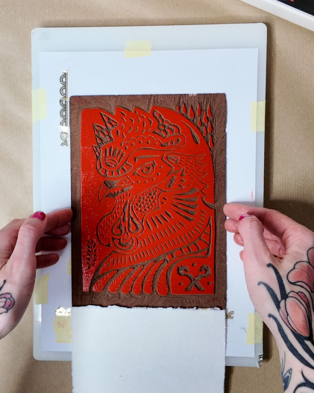 put inked lino plate down