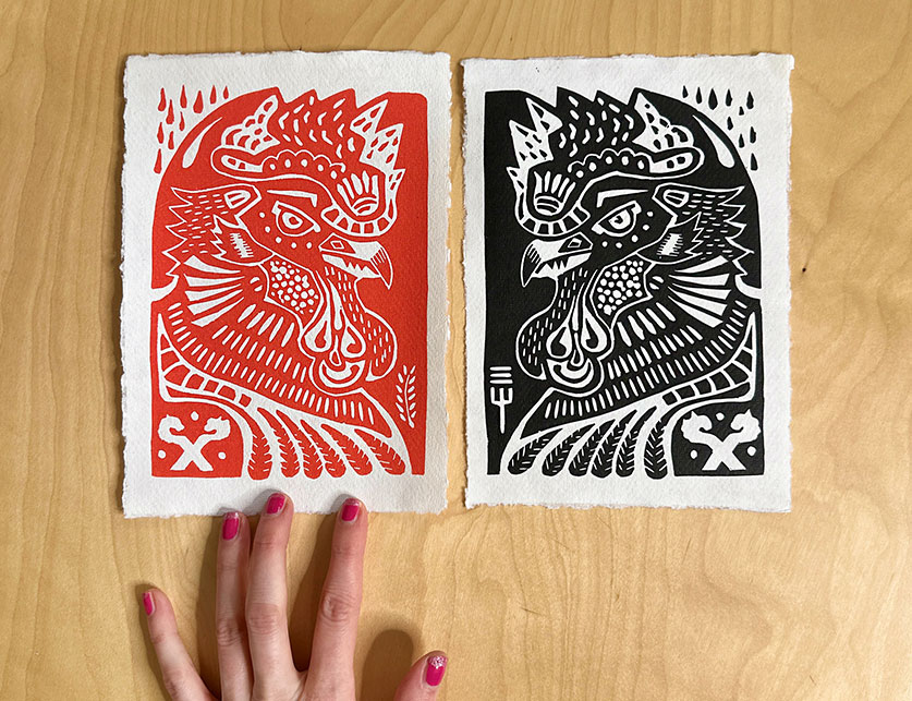 red and black rooster linoprint next to each other